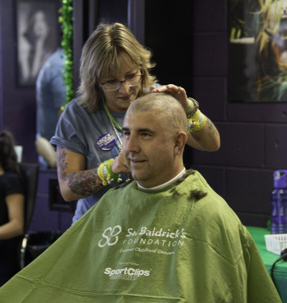 The Fountain Police Department sponsored Scott Gilbertsen, who had his head shaved by Jenn Andersen, on Saturday at Jimmy's Tavern in Pueblo West to raise money for the St. Baldrick's Foundation. [CHIEFTAIN PHOTO/ZACHARY ALLEN]